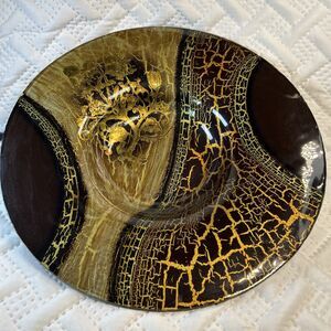 Glass bowl features an asymmetrical shape with a striking black and gold crackle